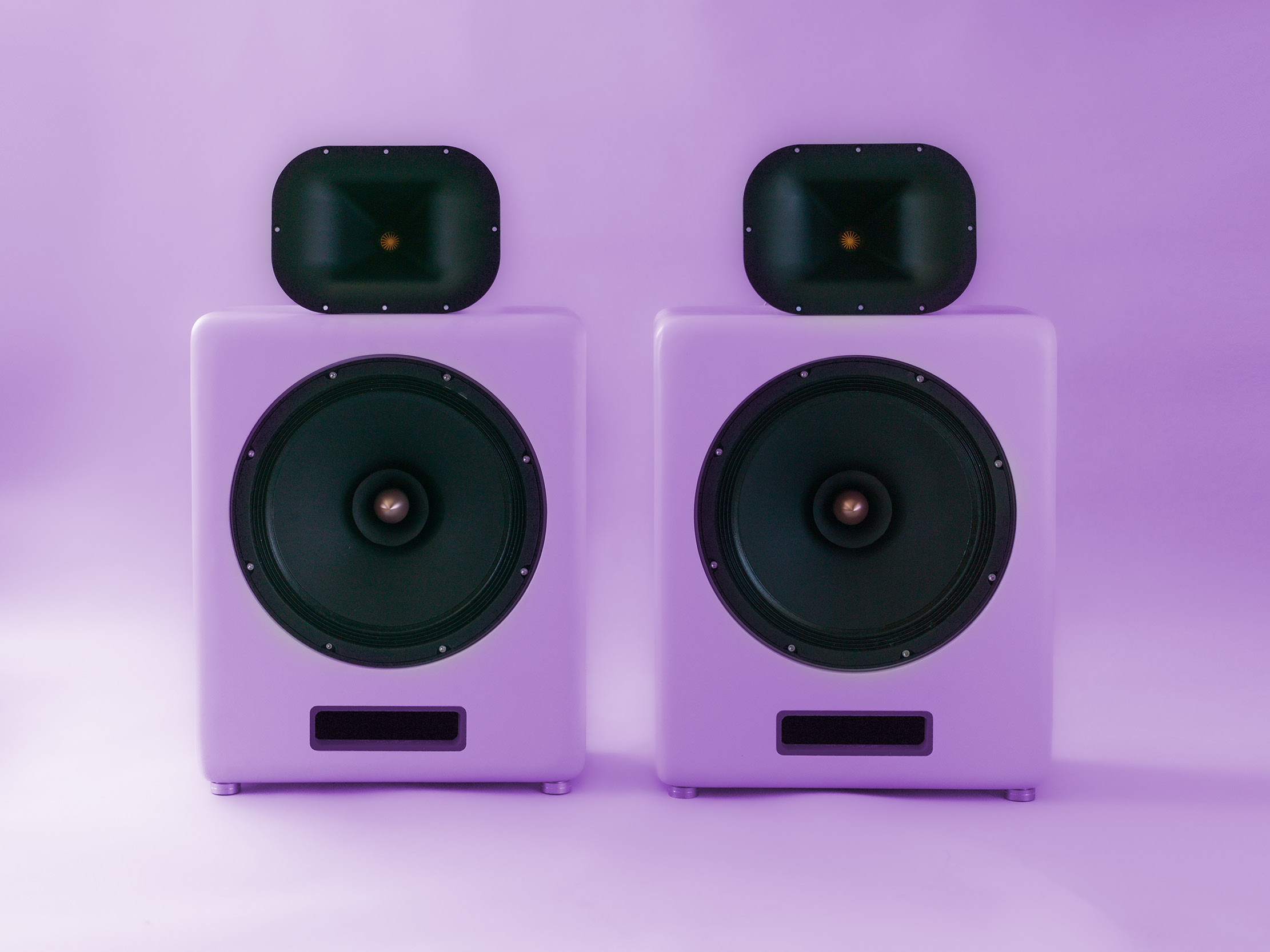 Two white Cobalt loudspeakers with black horns under violet lighting, from the collector catalogue